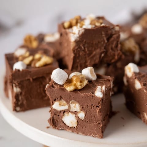 Melted chocolate and marshmallow-filled Rocky Road Fudge, ready to be chilled and enjoyed.