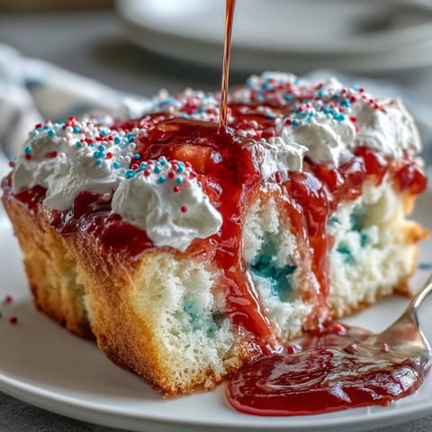 Memorial Day Red White Blue Poke Cake, vibrant swirls on fluffy white cake.