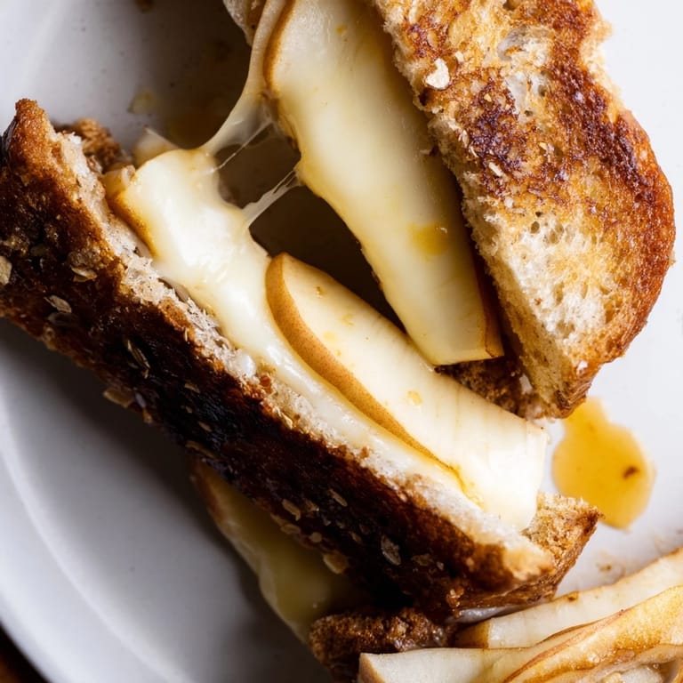 This vegetarian grilled cheese pairs tangy apple with smoky cheese, served warm for a comforting lunch.